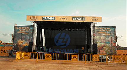 HUAYUAN mobile stage semi-trailer in Benin with MTN and CANAL+ banners at outdoor event